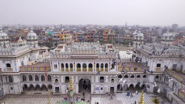 Aerial view over the city of Janakpur as a flock of pigeons fly by Janaki Temple in Nepal.