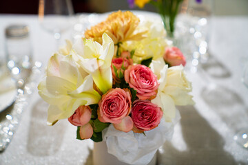 Beautiful bouquet of colorful flowers in a hat box on the dining table. 