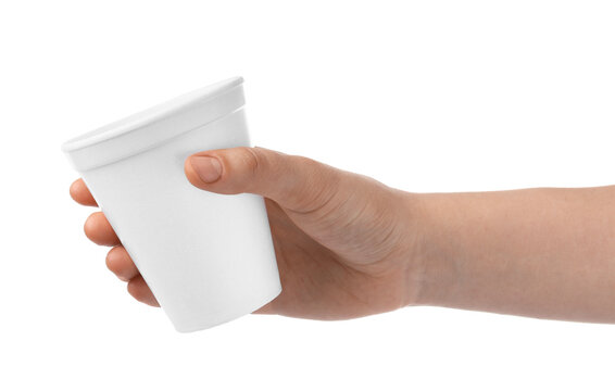 Woman holding styrofoam cup on white background, closeup