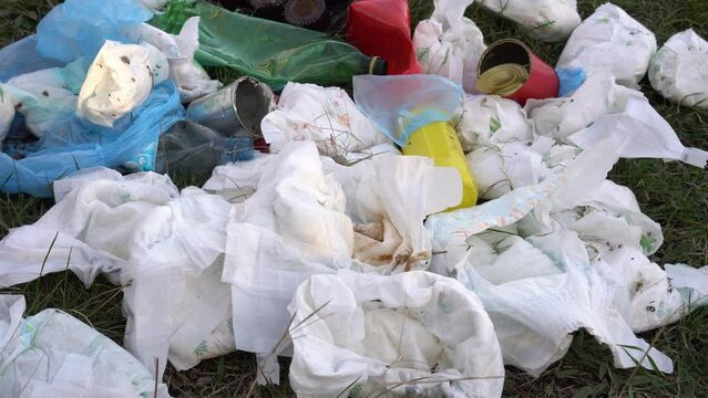 A pile of discarded used baby diapers in landfill. Effects of Disposable Diapers on Environment. Soil, water and air pollution
