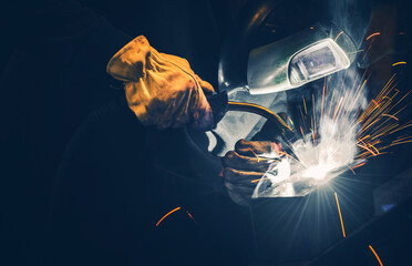 Professional Welder Welding Metal Pieces