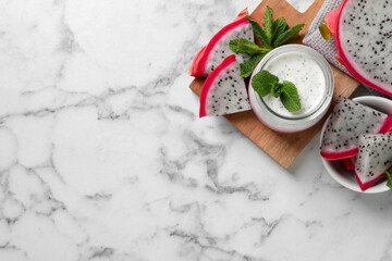Tasty pitahaya smoothie, dragon fruits and fresh mint on white marble table, flat lay. Space for...