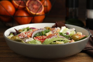 Bowl of delicious sicilian orange salad on wooden table, closeup