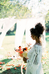 Woman in the garden against the background of white curtains. Side view