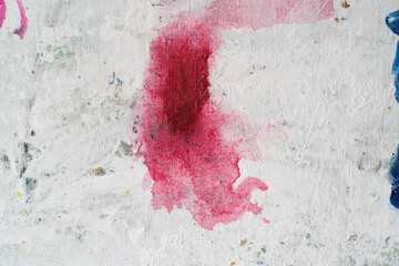 multicolored paint stain on a white wall