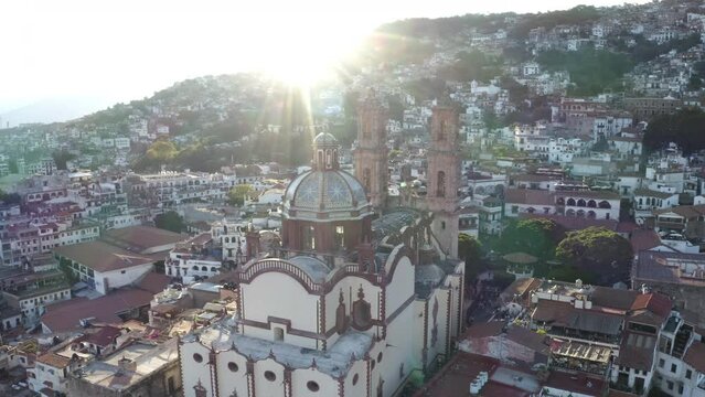 Santa Prisca Catholic Church and Cityscape of Taxco de Alarcon, Mexico, Drone Aerial View With Evening Sunlight as Backlight