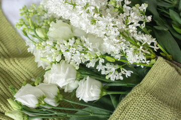 Eco fashion blogger content with clothes flat lay and white flowers