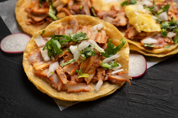 Pork tacos called al pastor with pineapple and sauce. Mexican food