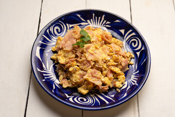 Scrambled eggs with ham for breakfast