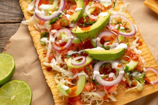 Snack made with wheat flour called chicharron preparado with sauce and vegetables. Mexican food