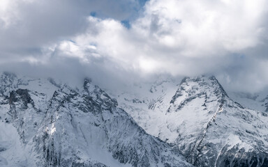 Fototapeta na wymiar Mountain top surrounded by clouds. Greater Caucasus ridge