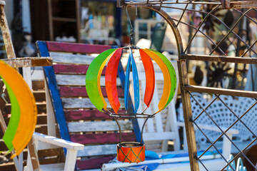 a colorful hot air balloon shaped wind spinner hanging in an antique store surrounded by various...