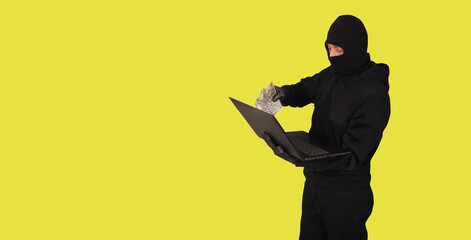 Hacker with laptop on color background. Cybercrime concept