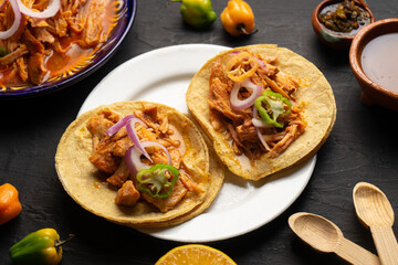 Cochinita pibil tacos with habanero pepper and purple onion. Mexican food