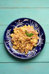 Scrambled eggs with ham for breakfast