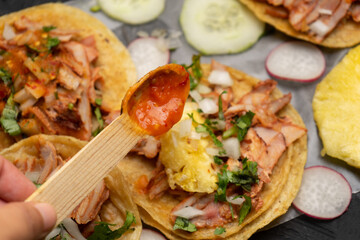 Pork tacos called al pastor with pineapple and sauce. Mexican food