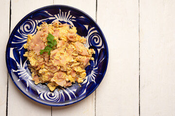 Scrambled eggs with ham for breakfast