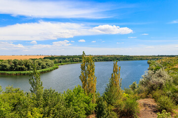 Summer landscape with beautiful river, green trees and blue sky