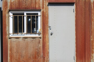 Locked entrance to rusty shipping container house