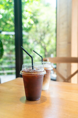 iced black coffee takeaway glass on table in coffee shop cafe restaurant