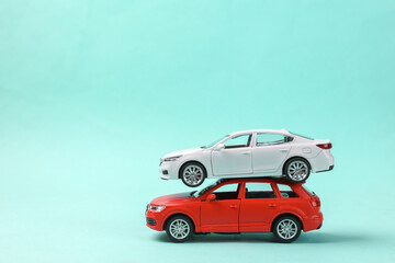 Two toy car models on a blue background