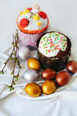 cake with swiss meringue. Spring blossom and colorful painted eggs. Person decorates cake with hand.
