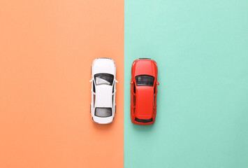 Model of two toy car on blue-pink background. Top view. Flat lay