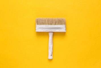 Paint brush on yellow background. Minimalism