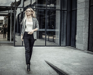 Confident business woman going out from business office