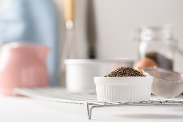 Organic perilla seeds in a ceramic bowl on white background. Natural products, healthy baking ingredients
