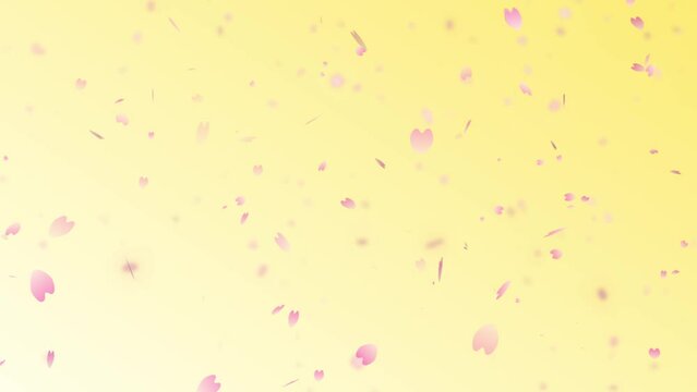 黄色の背景の桜の花びらの花吹雪