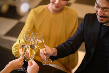 Image of a man and a woman toasting at a party Overhead Front Bokeh