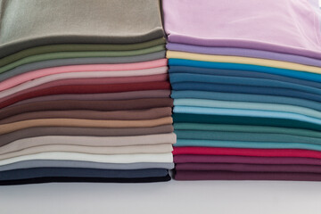 Rolls of bright colored fabric on a white background.