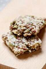 A muesli bar with seeds on a wooden table.