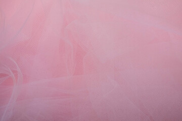 delicate airy white fabric with folds on a pink background