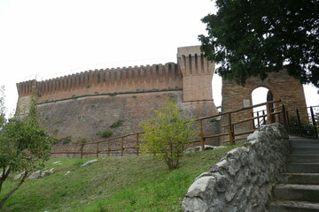 the fortress of Brisighella with mighty brick walls, two towers and the patrol walkway stands on a hill that dominates the village