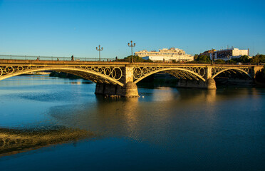 Fototapeta na wymiar the Triana bridge over the Guadalquivir river in Seville, Spain