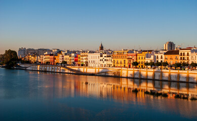 Fototapeta na wymiar the Guadalquivir River flows near the Triana neighborhood in Seville, Spain