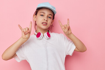 Portrait of happy smiling child girl wearing headphones posing emotions isolated background