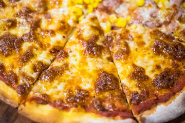Delicious pizza served on wooden plate