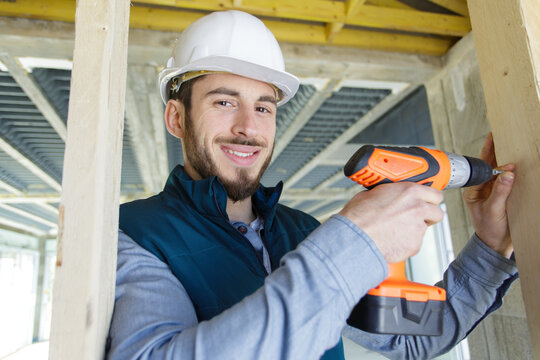 young builder using a cordless drill