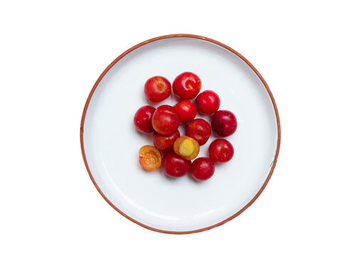 Red Camu Camu fruit on white plate isolated on white background. Camu Camu is a fruit of South American.