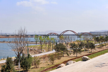 Scenery of a large river bank and Bridge