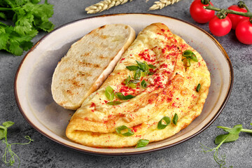 Delicious baked omelet with vegetables on the breakfast table close-up