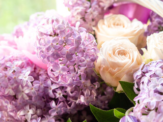 Bouquet of white roses and lilacs in close-up. Gifts and Greetings Happy Holidays.