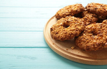 Peanut cookies on cutting board on blue background. Bakery products.