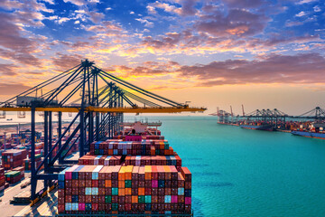 Aerial view of cargo ship and cargo container in harbor.