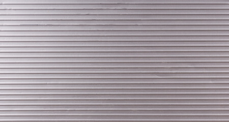 silvery metal surface with horizontal stripes and scratches
