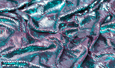 Fabric with sequins as a background. Glittery texture is the trend of the season. Sparkling color...
