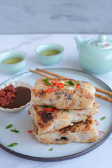 Popular Chinese New Year food. Turnip Cake aka Lo Bak Go. Actually made from radish and rice flour. For own consumption, you can add ground pork, diced Chinese sausage and mushroom and pan fried.